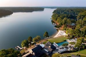 an aerial view of a house on the shore of a lake at The Ritz-Carlton Reynolds, Lake Oconee in Turnwold