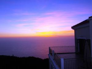 a sunset over the ocean from a building at Porto Katsiki Blu in Athani