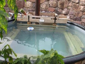 a small pool of water with a bench on top of it at Casa de Oren in Pisac