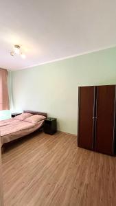 a room with a bed and a cabinet in it at Квартира рядом с морем (3-х комнатная) in Gagra