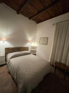 a bedroom with a large bed and a window at la rocca sul lago in Capodimonte