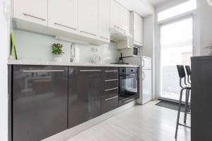 a kitchen with stainless steel appliances and white cabinets at City center 2bedroom apartment in Zagreb