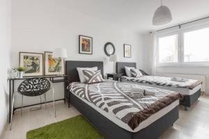 a bedroom with two beds and a chair in it at City center 2bedroom apartment in Zagreb