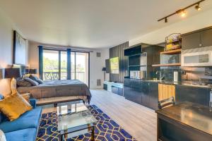 a living room with a couch and a kitchen at Henderson Vacation Rental with Balcony! in Las Vegas