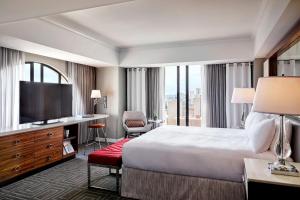 a hotel room with a bed and a flat screen tv at JW Marriott San Francisco Union Square in San Francisco