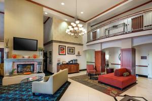 a living room with a fireplace and a tv at Fairfield Inn & Suites Tucson North/Oro Valley in Oro Valley