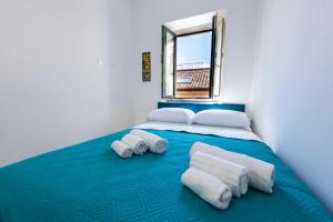 een slaapkamer met een groot bed met handdoeken erop bij Kapitano Apartments in Taormina +17 foto's