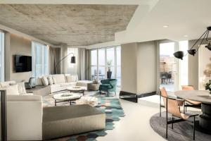 a living room with a couch and a table at the DOUGLAS, Autograph Collection in Vancouver