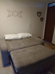 a bedroom with two beds and a heart on the wall at La Lunar un espacio ideal para trabajar y conocer Medellín in Medellín