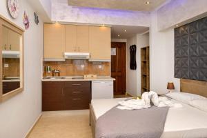 a small bedroom with a bed and a kitchen at COPA CABBANA in Nea Roda +44 photos