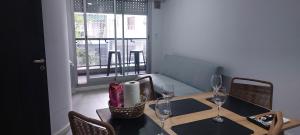 a table with chairs and wine glasses on it at Alquiler Temporario Rosario 10 in Rosario