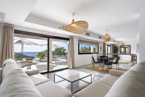 a living room with a couch and a view of the ocean at Buenavista Cala Salada in San Antonio