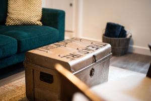 a living room with a green couch and a trunk at Sandals cottage in St Ives