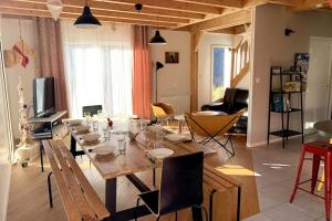 a dining room with a wooden table and chairs at Chalet Las Abelhas in Le Mont-Dore
