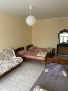 um quarto com 2 camas, um sofá e um espelho em Hotel Stella em Nova Athos