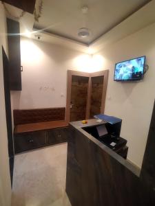 a room with a bar with a tv on the wall at Hotel Kishan Lodging & Boarding in Mumbai