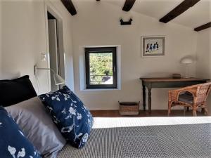 una camera da letto con un letto, una scrivania e una finestra di Two villas in lush countryside near Motovun a Brkač