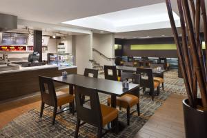 a restaurant with tables and chairs and a kitchen at Courtyard by Marriott Fishermans Wharf in San Francisco