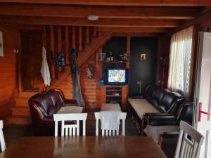 a living room with leather furniture and a tv at Stefan in Nikšić