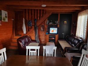 a living room with leather furniture and a tv at Stefan in Nikšić