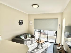 ein Wohnzimmer mit einem Sofa und einem Tisch in der Unterkunft Ballito Hills - Ocean View, Queen Bed & Free Wi-Fi in Durban