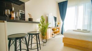 a bedroom with two bar stools and a bed in it at Royal Blue Resort & Residences in Tivat