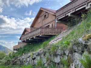 a house on top of a hill with a bridge at Chalet L'Ôbresse in La Bresse
