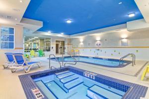 a swimming pool in a large room with a swimming pool at Fairfield Inn & Suites by Marriott Kamloops in Kamloops