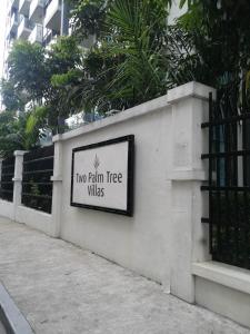a sign that says two palm tree villas on a wall at NAIA Condo Palm Tree 2 in Manila