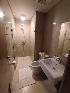 a bathroom with a shower and a toilet and a sink at NAIA Condo Palm Tree 2 in Manila