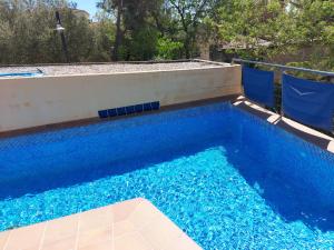 a swimming pool with blue water in a backyard at Allotjament Activitats Bora Bora-Empordà in Verges