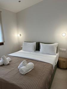 two towels on a bed with two pillows on it at Zinozis Beach Apartments in Vourvourou