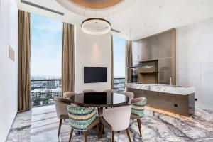 a dining room with a table and chairs at Renaissance Shanghai Caohejing Hotel in Shanghai