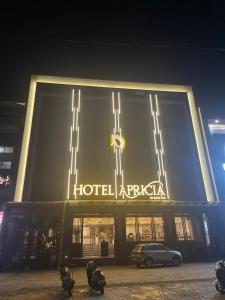 a building with a hotelaria sign on it at night at Hotel Apricia in Ludhiana