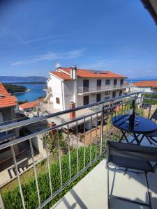 a balcony with a table and a view of the water at Jelsa Blue Sea View in Jelsa