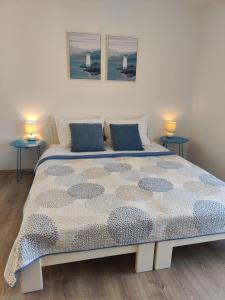 a bedroom with a large bed with two tables at Jelsa Blue Sea View in Jelsa