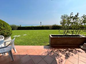 a potted tree in a planter on a patio at Residence Virgilio in Sirmione