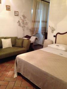 a living room with a bed and a couch at Affittacamere Casa Delle Rose in Antria +9 photos