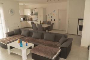 a living room with a couch and a table at Apartman Stella in Pula +6 photos