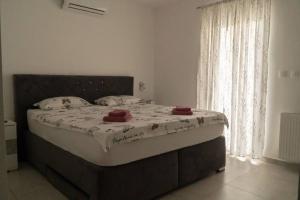 a large bed in a bedroom with a large window at Apartman Stella in Pula