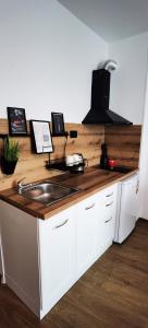 a kitchen with a sink and a wooden counter top at F 207 Primorsko del Sol - просторно студио с кухня in Primorsko