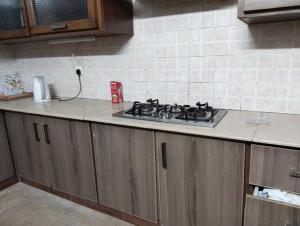 a kitchen with a stove top on a counter at Bourbon Bliss guest house in Rawalpindi