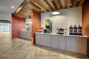 a restaurant with a counter with bottles of wine at Fairfield Inn & Suites Bardstown in Bardstown