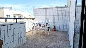a patio with two chairs and a table on a balcony at Apartamento Solzende in Esposende