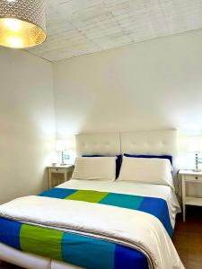 a bedroom with a colorful bed with two night stands at Cortile Sant'Agostino - Suites & Rooms in Mazara del Vallo +116 photos