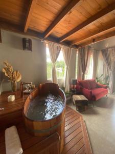 a living room with a large tub in the middle at Bombinhas Guest House in Bombinhas