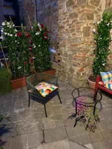 a patio with chairs and potted plants and flowers at San Giorgino Home in Florence