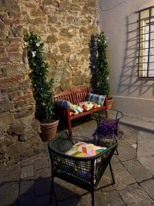a patio with a bench and a table at San Giorgino Home in Florence