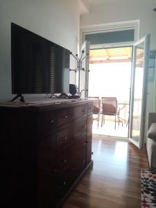 a dresser with a television on top of it in a living room at Apartment Perica in Dubrovnik