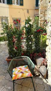 a chair with a colorful pillow sitting in a garden at San Giorgino Home in Florence